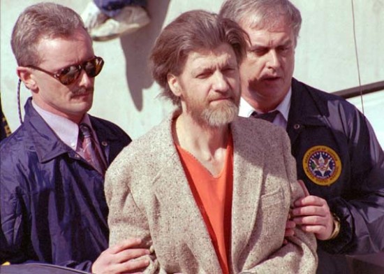 Theodore John Kaczynski is flanked by federal agents as he is led to a car from the federal courthouse in Helena, Mont., Thursday, April 4, 1996.  Kaczynski, the suspected Unabomber, was charged with one count of possession of bomb components.  (AP Photo/John Youngbear)